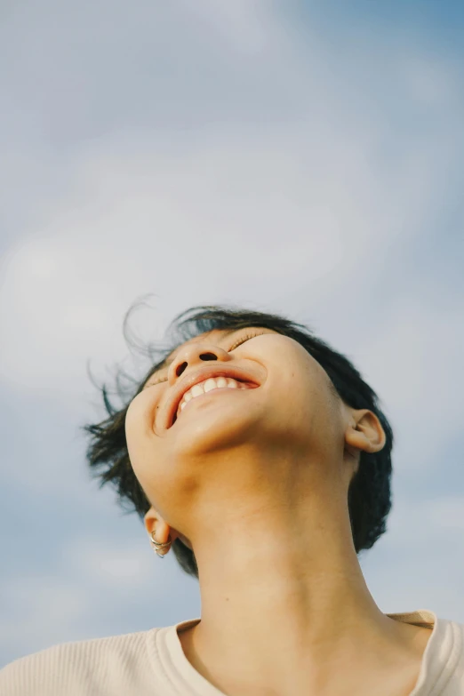 a woman laughing and holding a toothbrush in her mouth