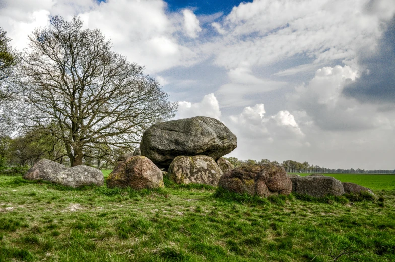 a stone rock sits on top of some grass