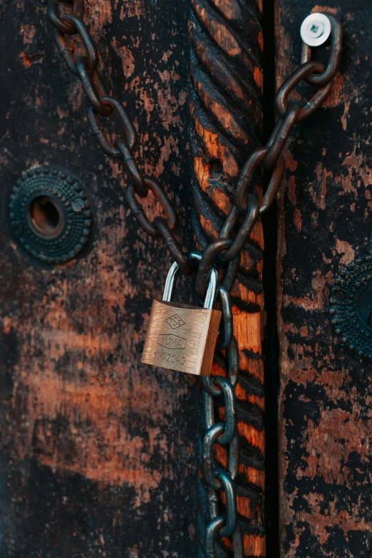 there is a metal chain hanging over the padlock