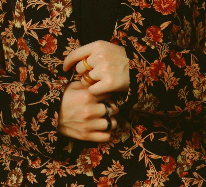 a person is holding onto their wedding rings