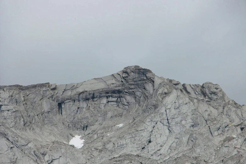 a rocky mountain ridge under an overcast sky