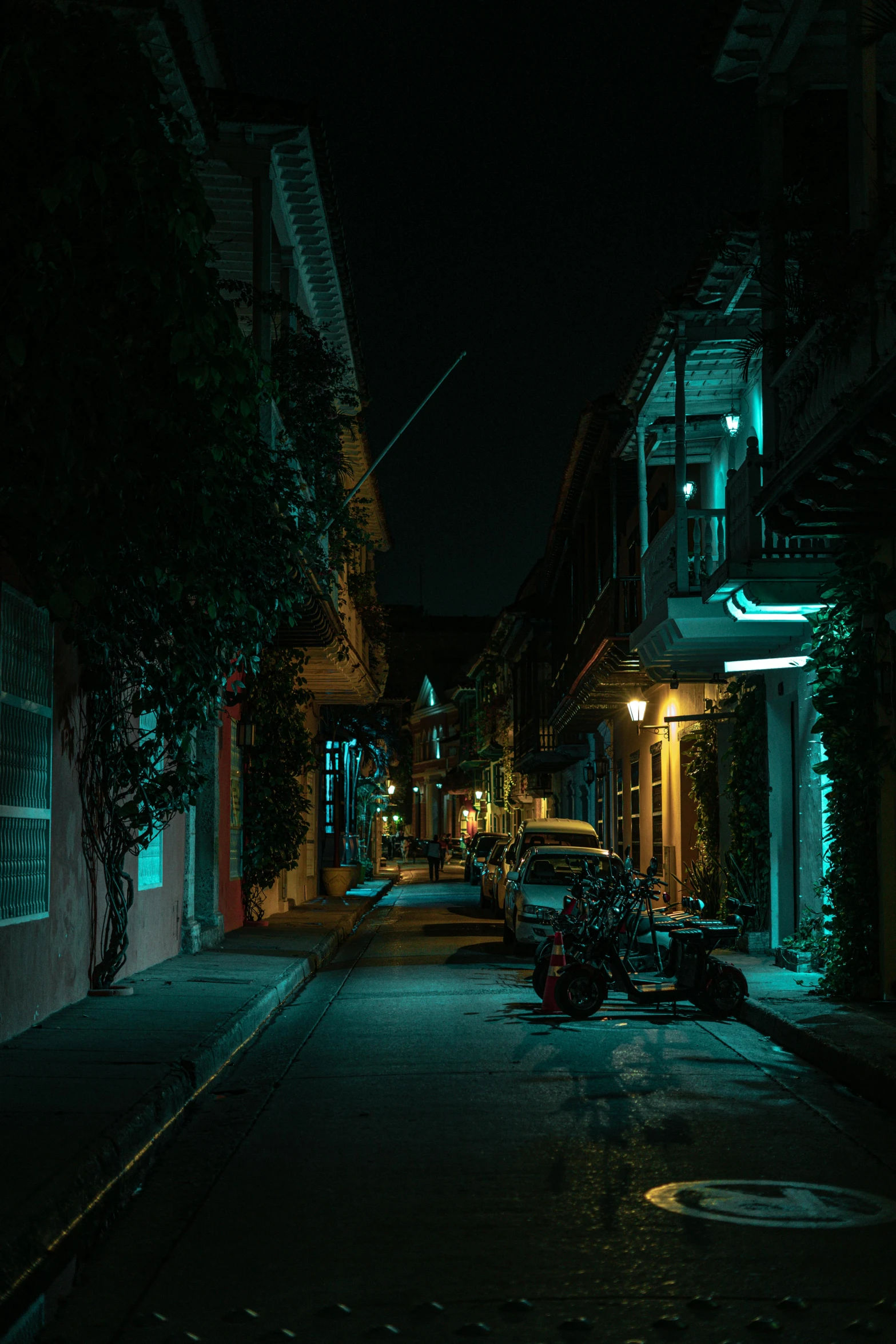 a city street at night with street lights shining in the background