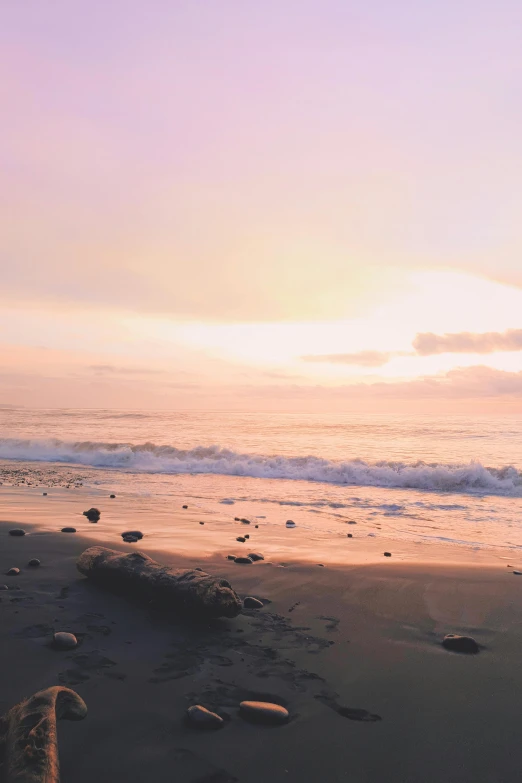 a beach area with waves crashing on shore