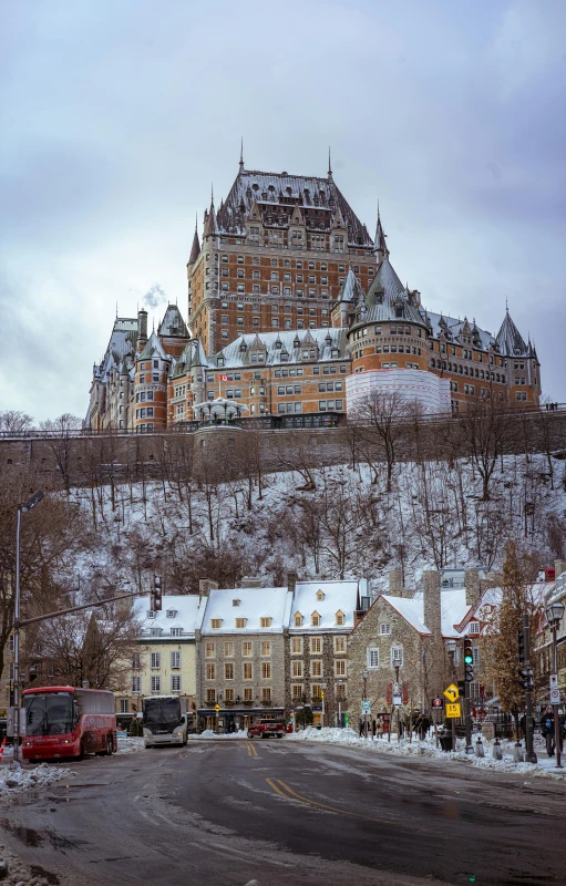 a castle is shown covered in snow and surrounded by buildings