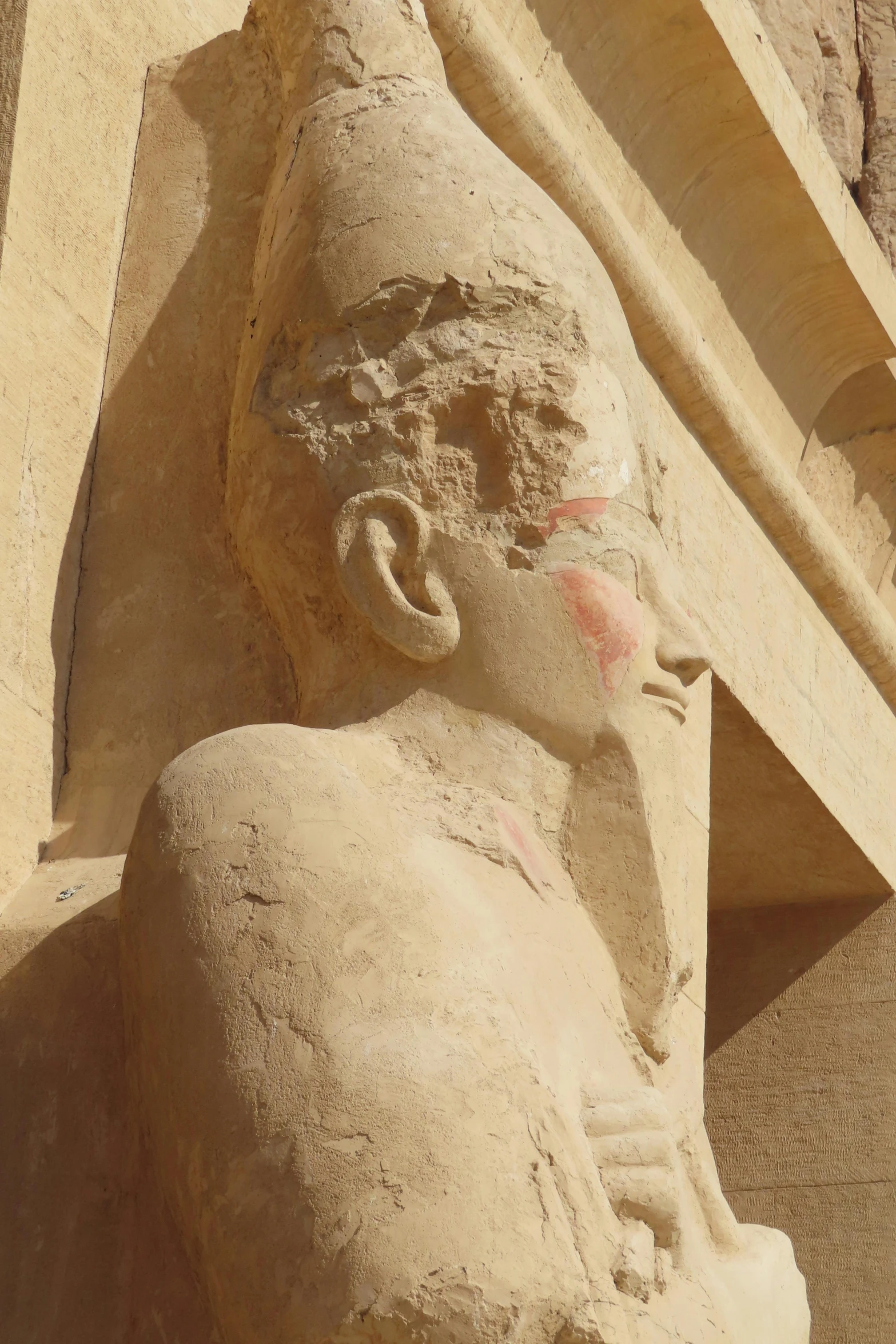 a close up of a head and torso of a statue