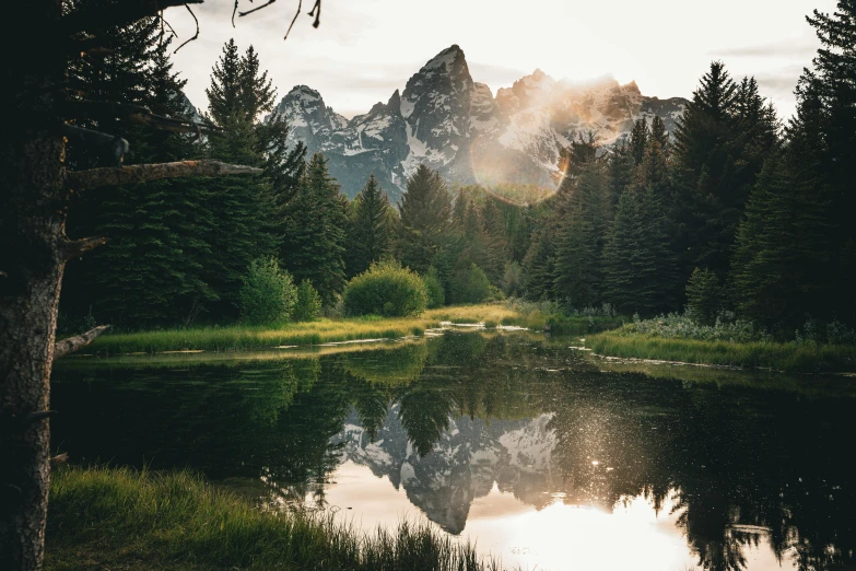 a mountain range is reflected in the water