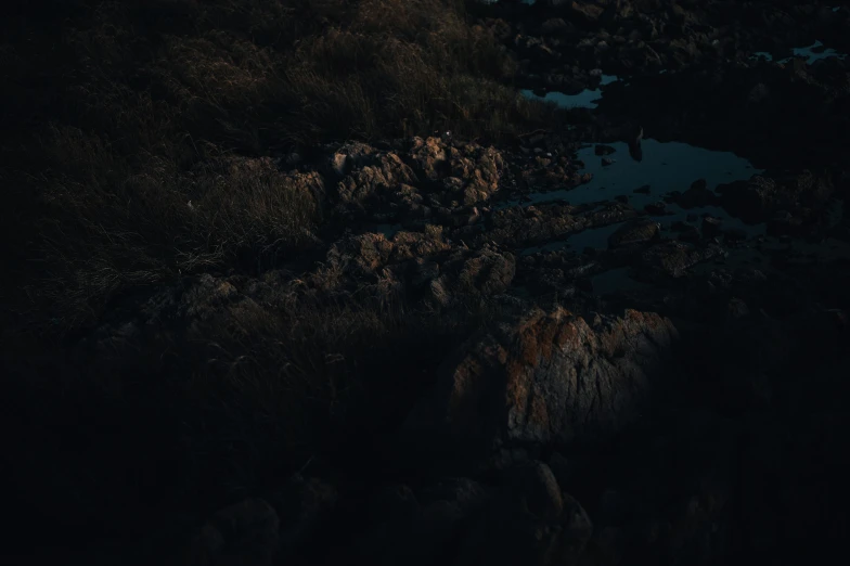 two lights hanging over rocks on the ground