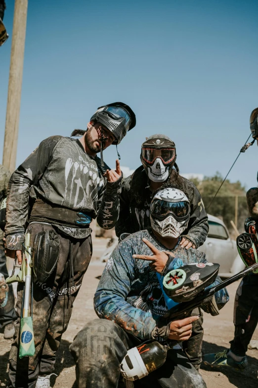 people are standing around wearing helmets and knee pads