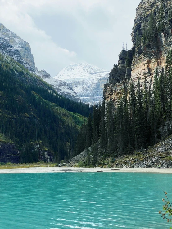 the mountain is surrounded by a clear blue lake