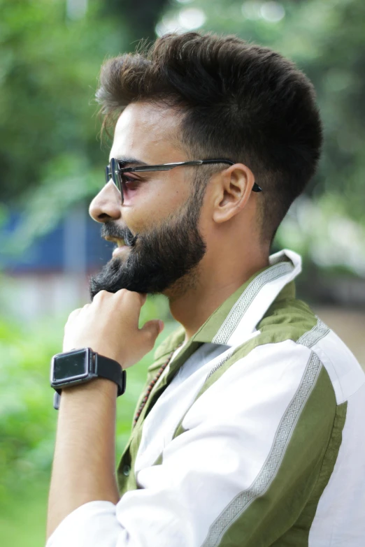 man with sunglasses on with his chin resting on the hand