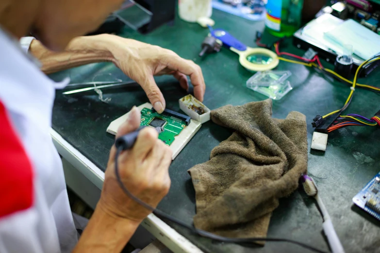a person that is working on some electronics