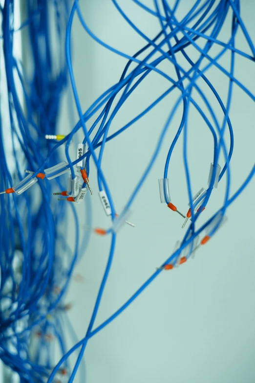 a blue string is tangled in a bunch of wires