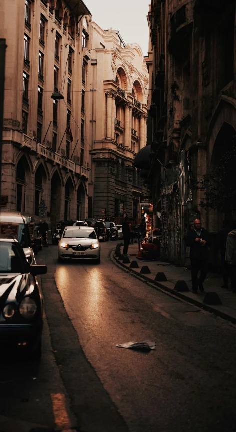 a city street with people walking, cars and buildings