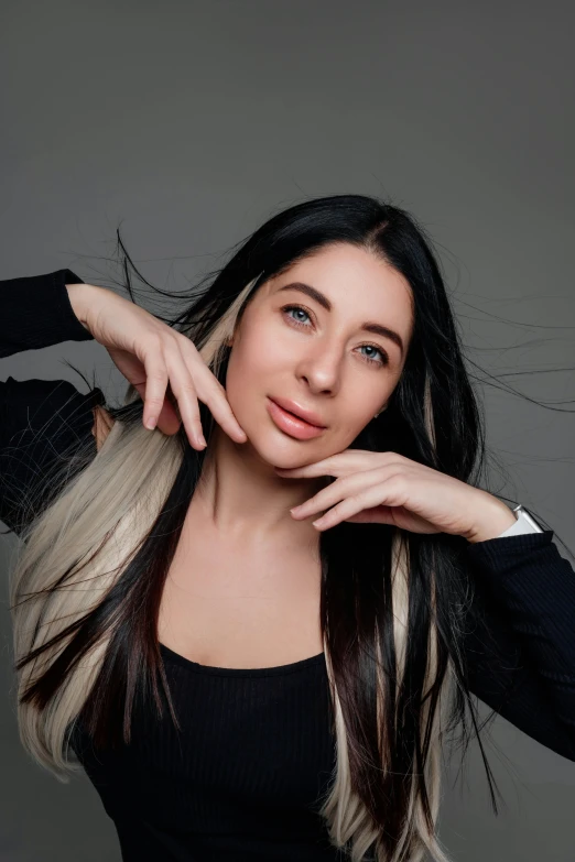 a beautiful woman with long dark hair poses for a picture