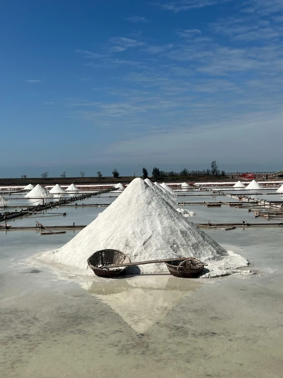 two old baskets and two white sand mounds