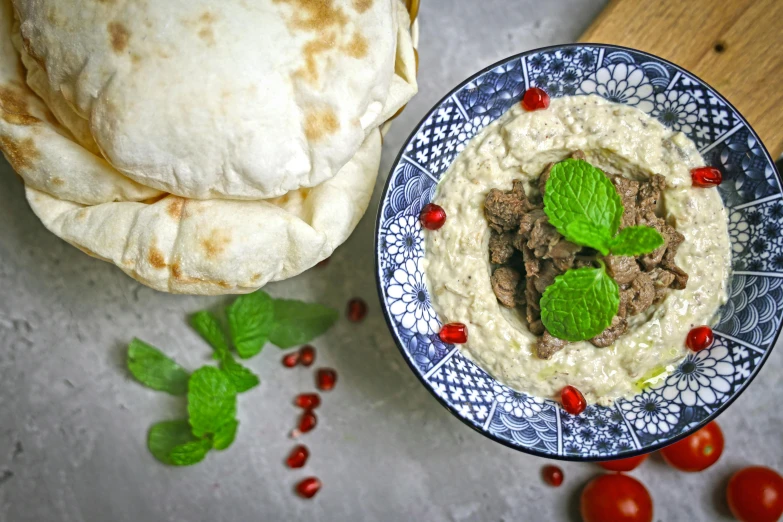 the bowl is filled with a sauce made of meat and other ingredients