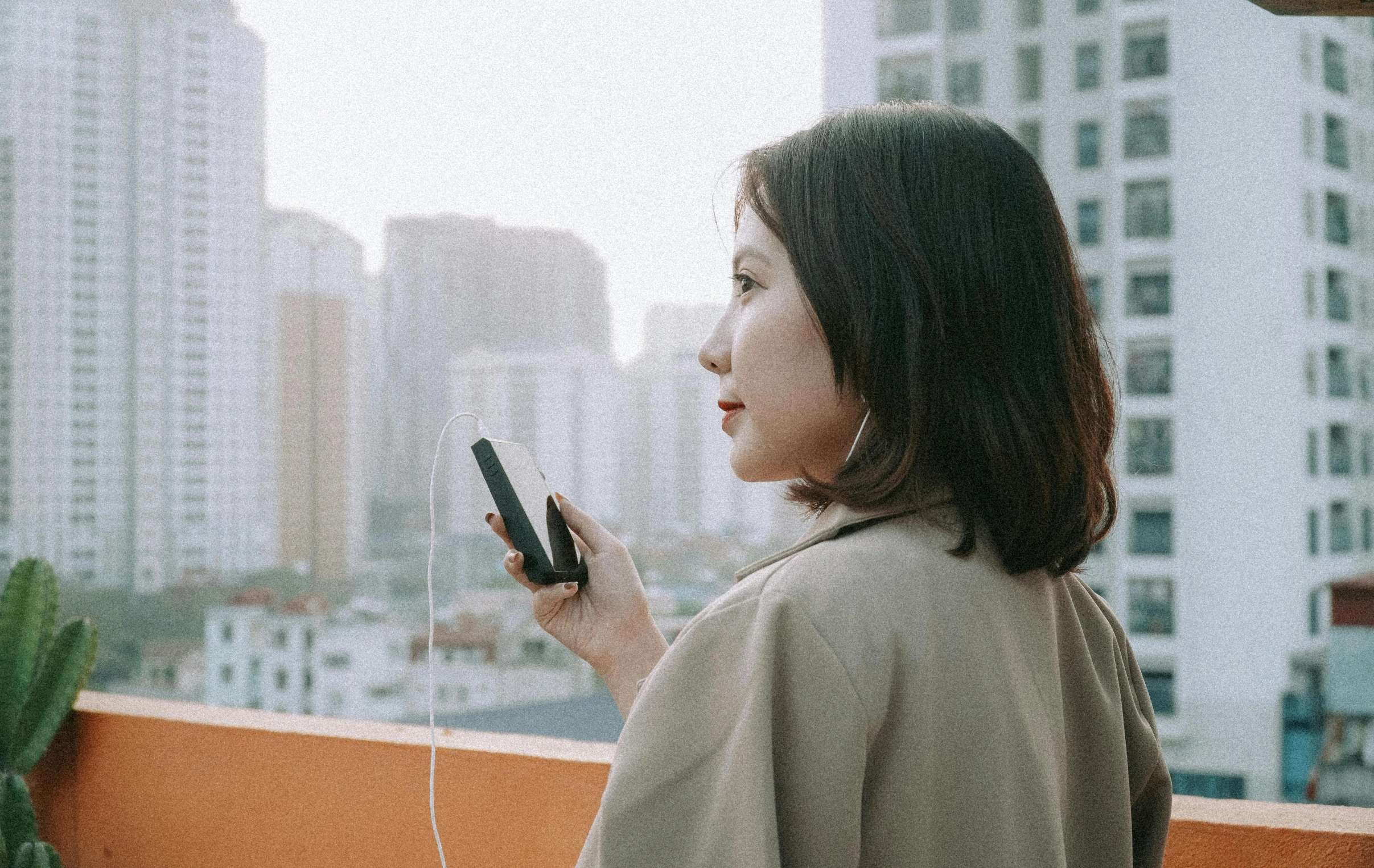 an asian woman looking out at the skyline