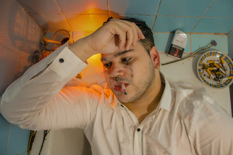 a young man making faces with his fingers in the mirror