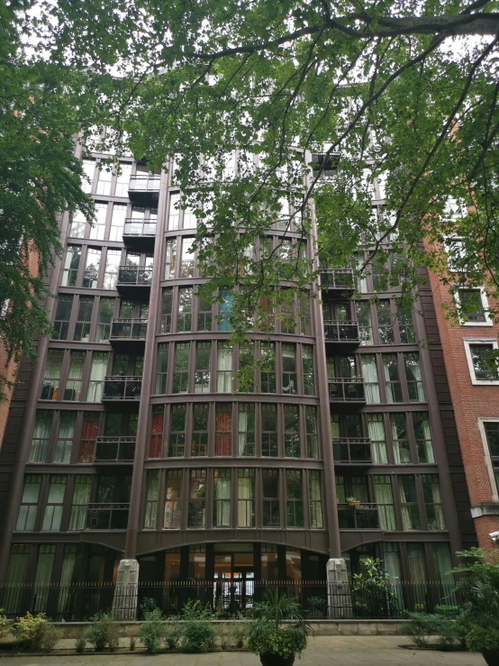 several tall buildings near each other next to trees