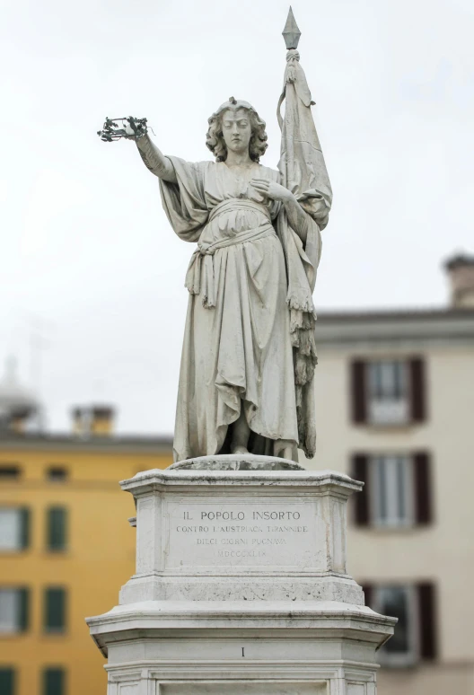 statue of a roman woman holding flowers on the top of a pedestal
