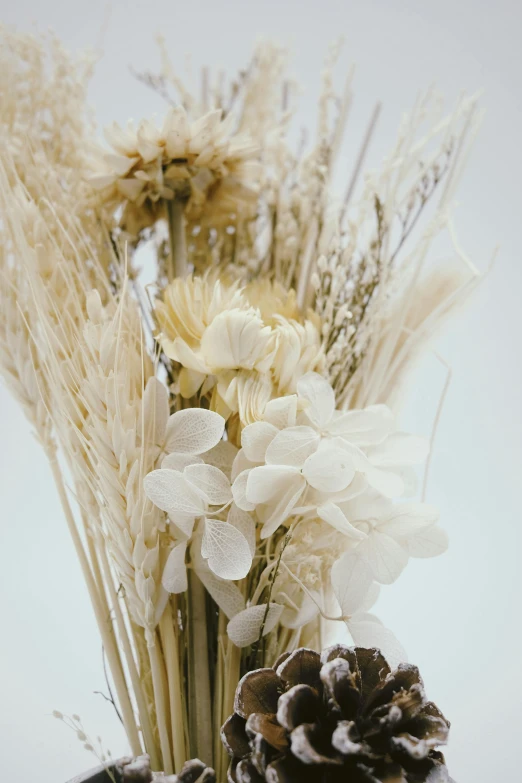 a bunch of flowers in a white vase