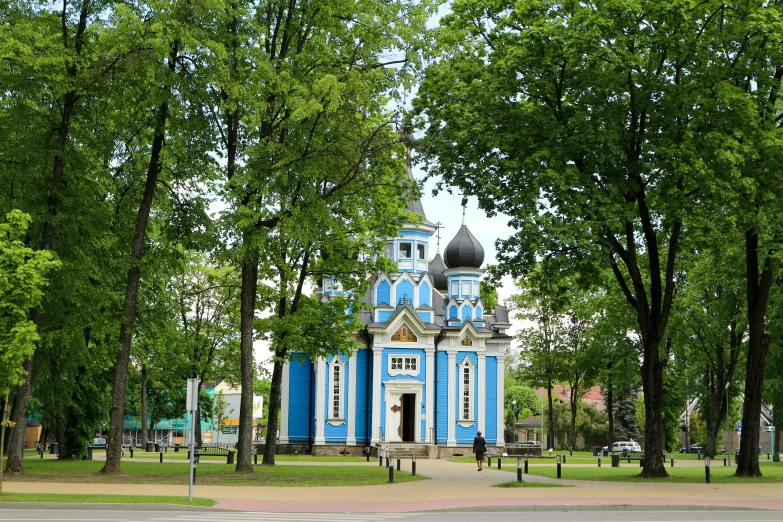 a large blue building sitting among tall trees