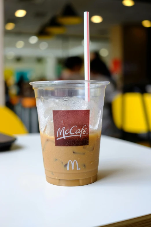 an iced mcdonald's coffee drink with a paper straw