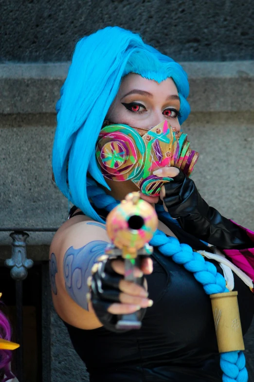 woman in makeup and face paint holding a gun