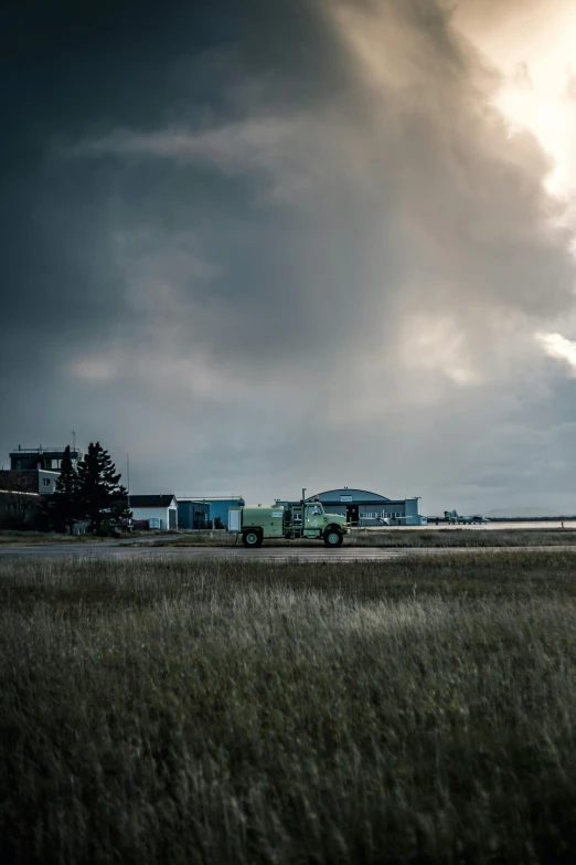 long distance view of a green truck in the grass