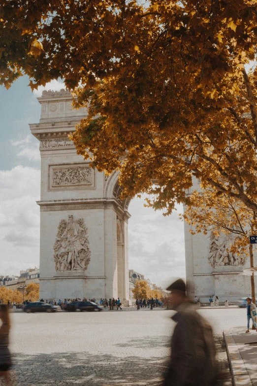 a big monument with people walking through it