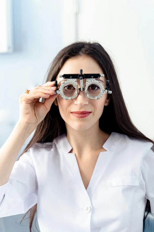 a woman wearing glasses and sitting down