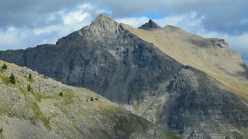 two peaks with a very small tree standing on the top