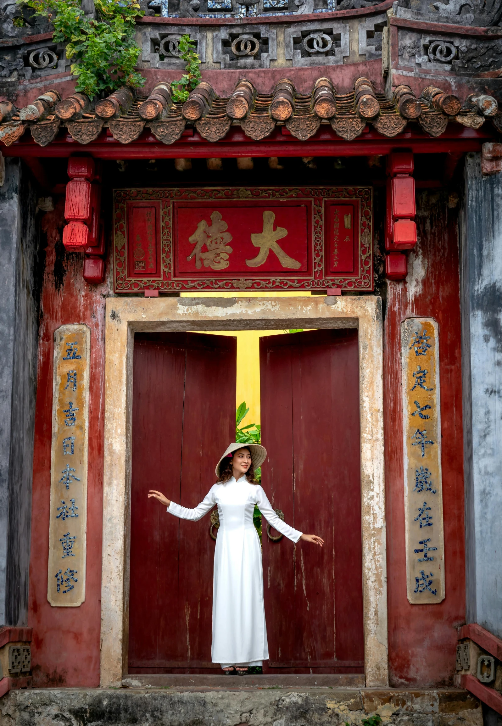 a woman in white dress in front of a doorway