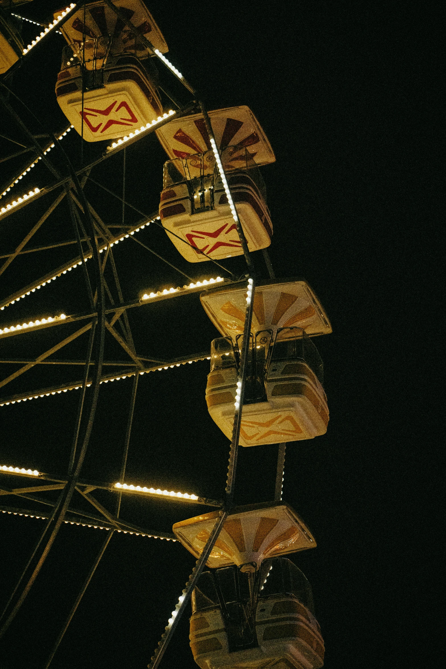 an amut ferris wheel is lit up with holiday lights