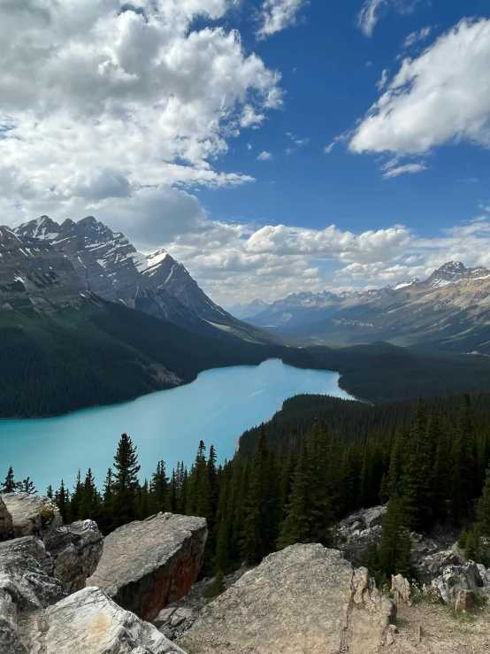 two big pretty mountains next to a lake