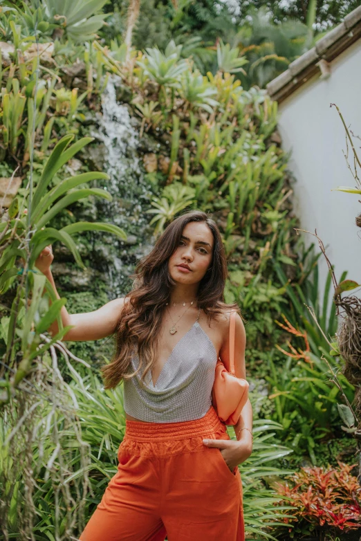 a beautiful woman posing in front of flowers