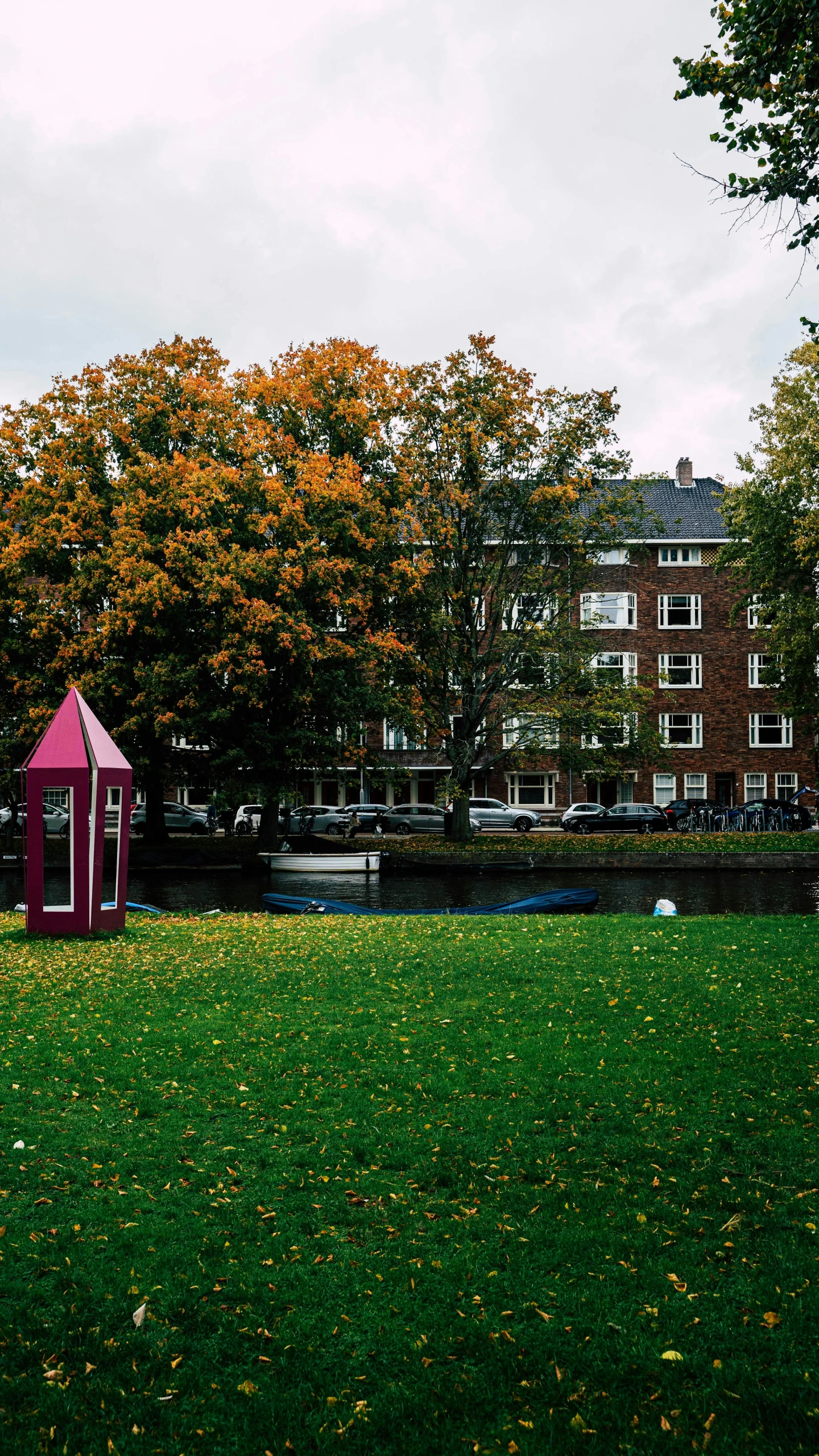 an open field with a small red structure in it