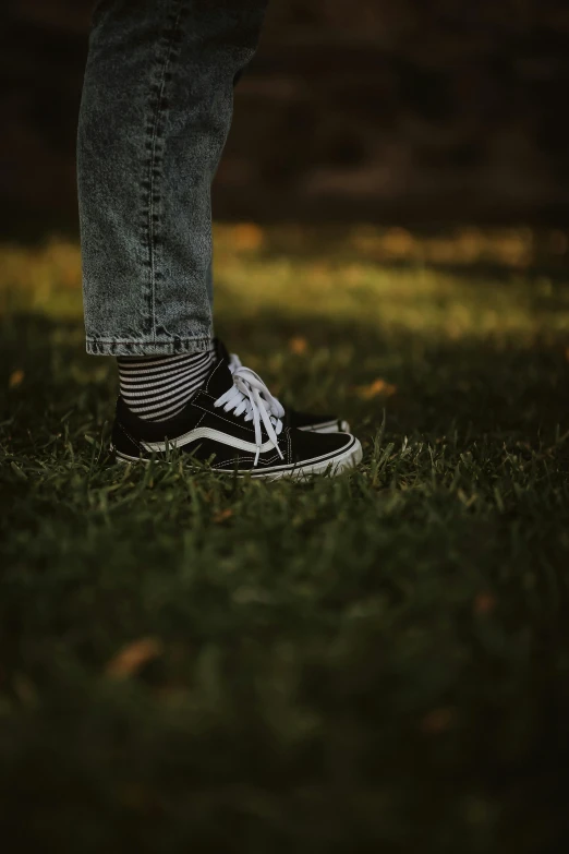 a person's shoes that are in the grass