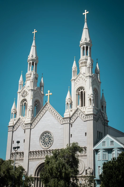 a white church that has a big cross in front