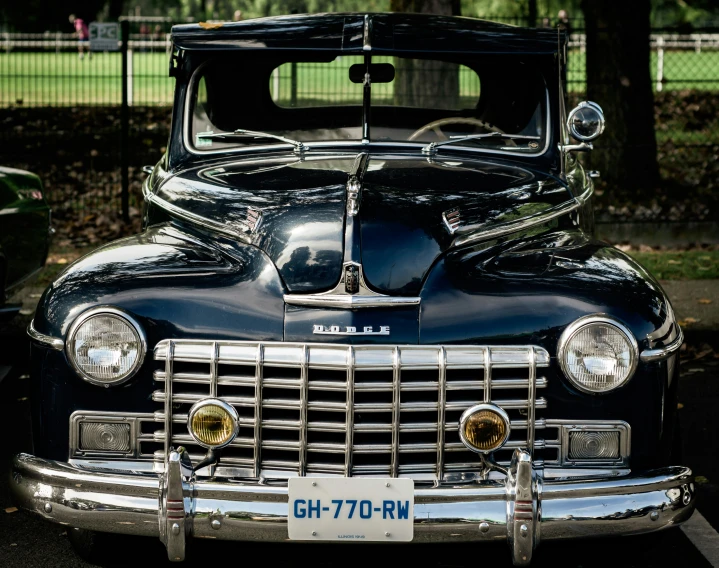 a car parked in a parking lot near many trees