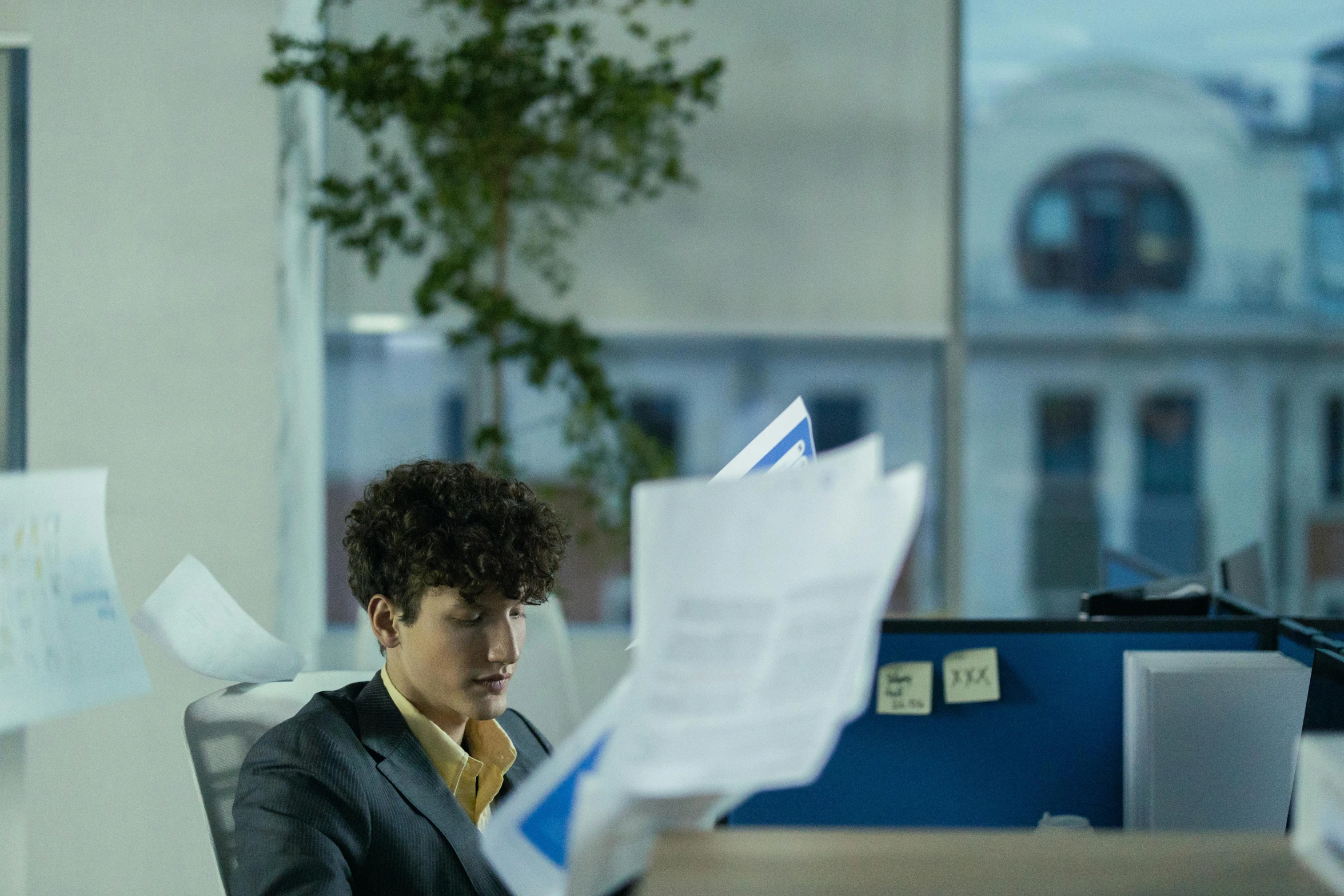 a young person looking over documents on a table