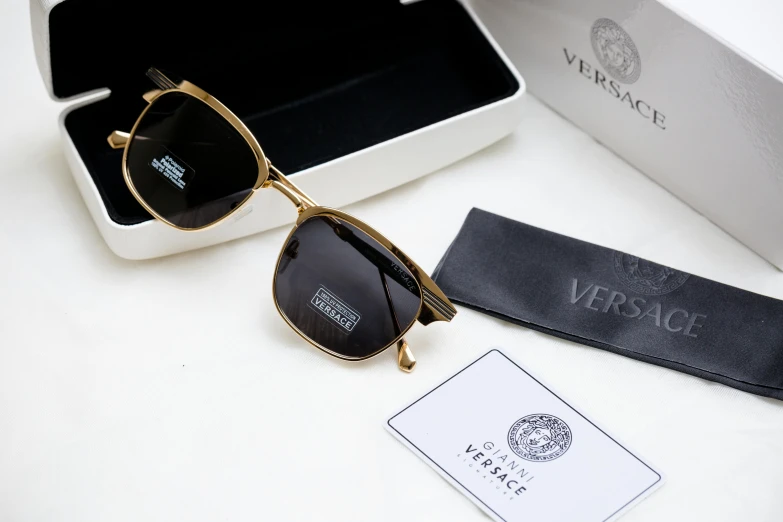 a pair of sunglasses is set next to a visa card