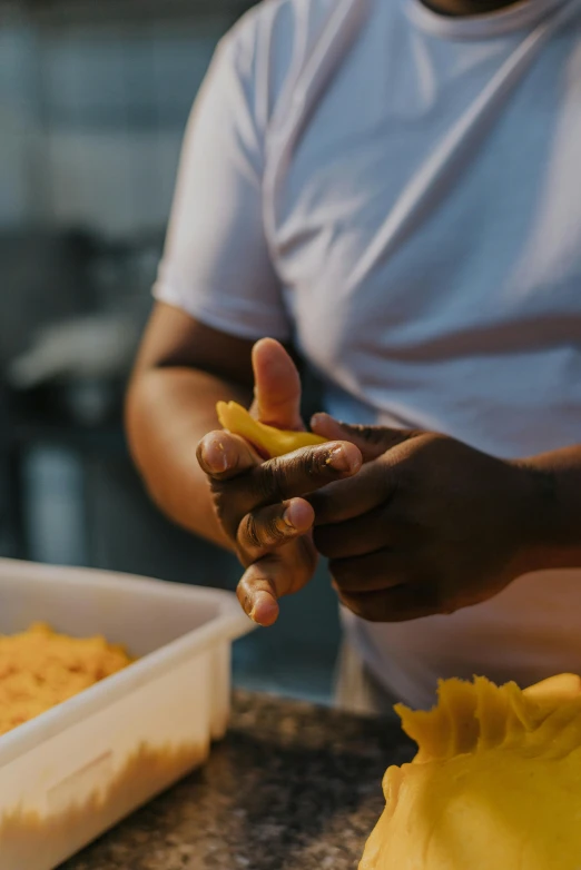 someone is putting some kind of food into a pan