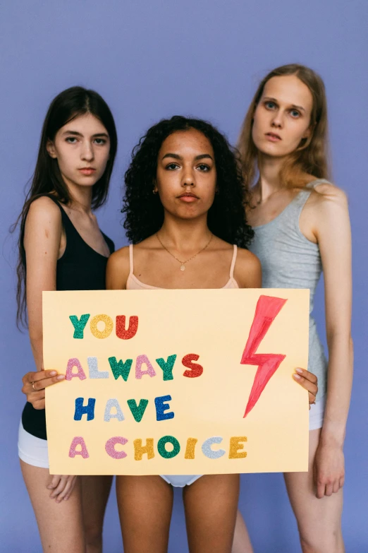 three girls holding up a sign that says you always have a choice