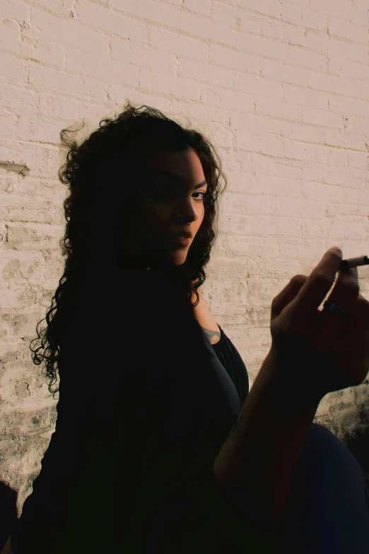 a woman holding her pen in her left hand