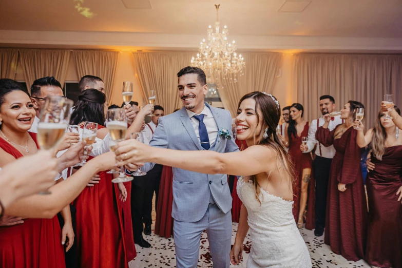 a man and woman with hands on wine glasses are giving each other a toast