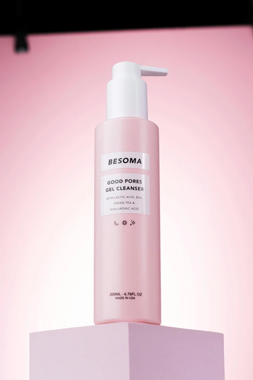 a bottle of toneless toneless conditioner on a pink and white block