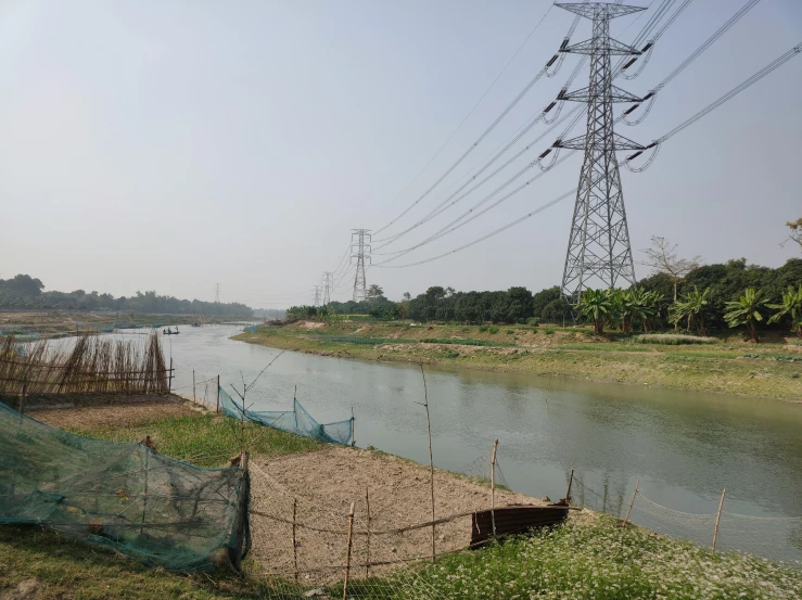 power lines are hanging above the river bank