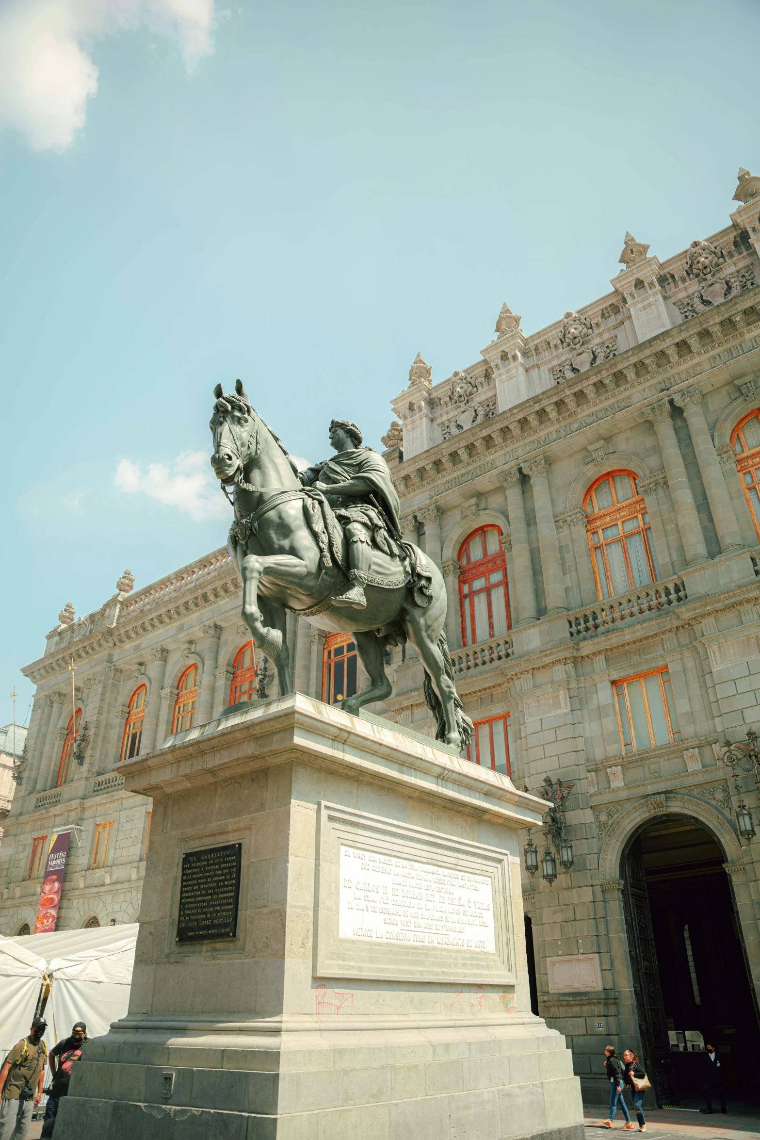 a statue on a pedestal in front of a building