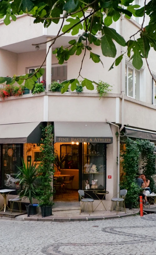 an outdoor cafe in the city where all tables and chairs are arranged